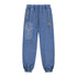 Blue denim jogger pants with geometric design on a white background